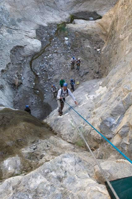 A second volunteer is belayed on the rock wall